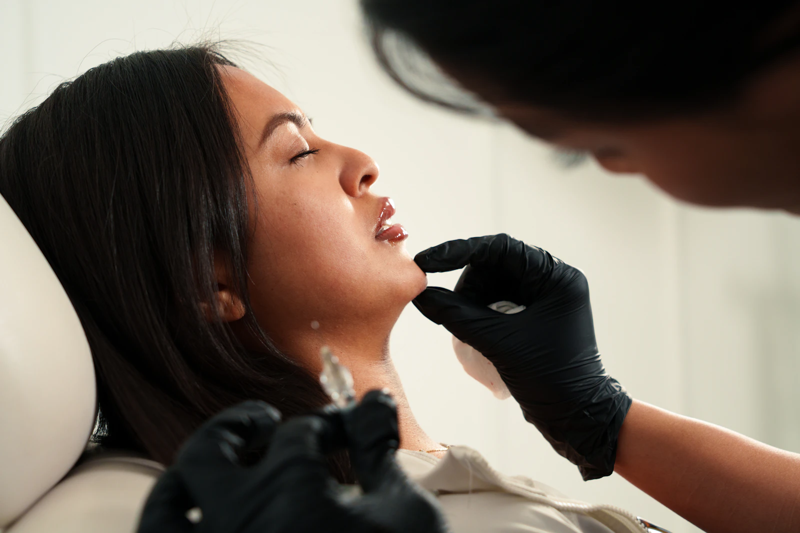 Aesthetic practitioner assessing a client's facial profile