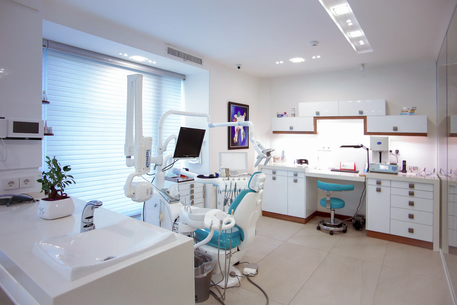 Modern dental treatment room with a dental chair and equipment